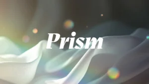 The word “Prism” in white serif font over a soft-focus abstract background with flowing fabric-like shapes and light refractions creating rainbow-coloured bokeh effects.