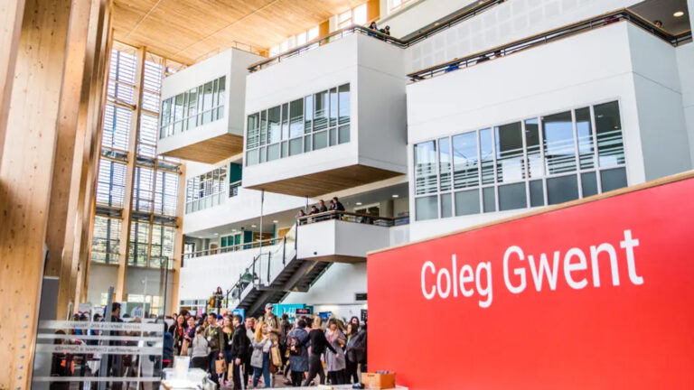 a photo of the internal architecture of a building with a red sign that reads "Coleg Gwent"